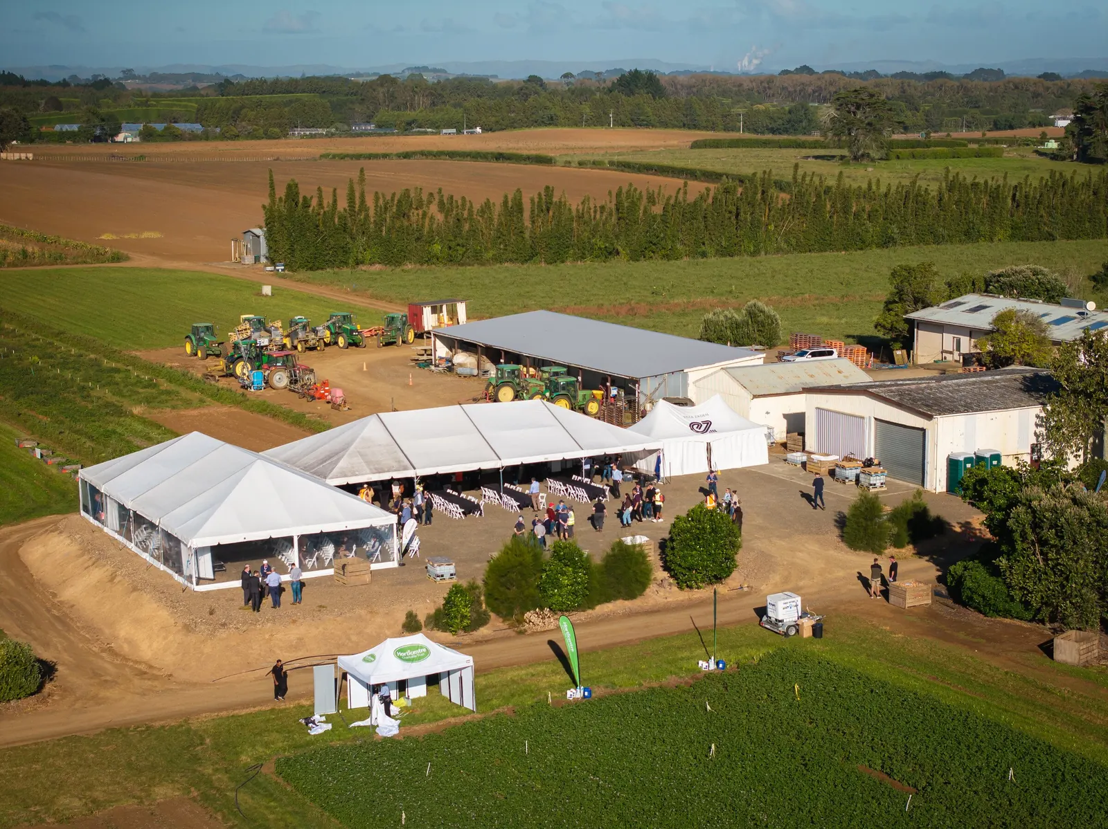 Aerial view of marquees set up for an industry field day on a working farm