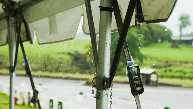 Rain running off a marquee frame and strapping on location